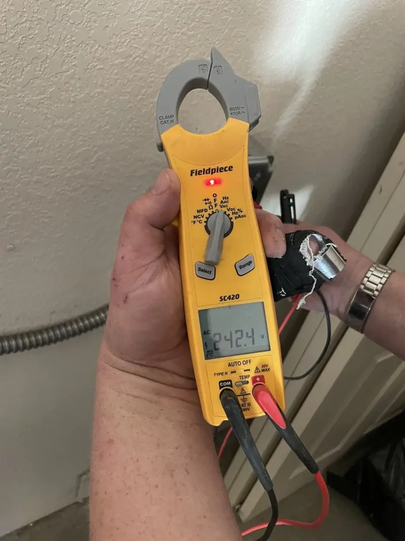 Voltage testing with clamp meter during Ceiling Fan Installation in Vernon